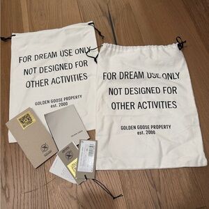 Golden Goose White Drawstring Bags with Black Text